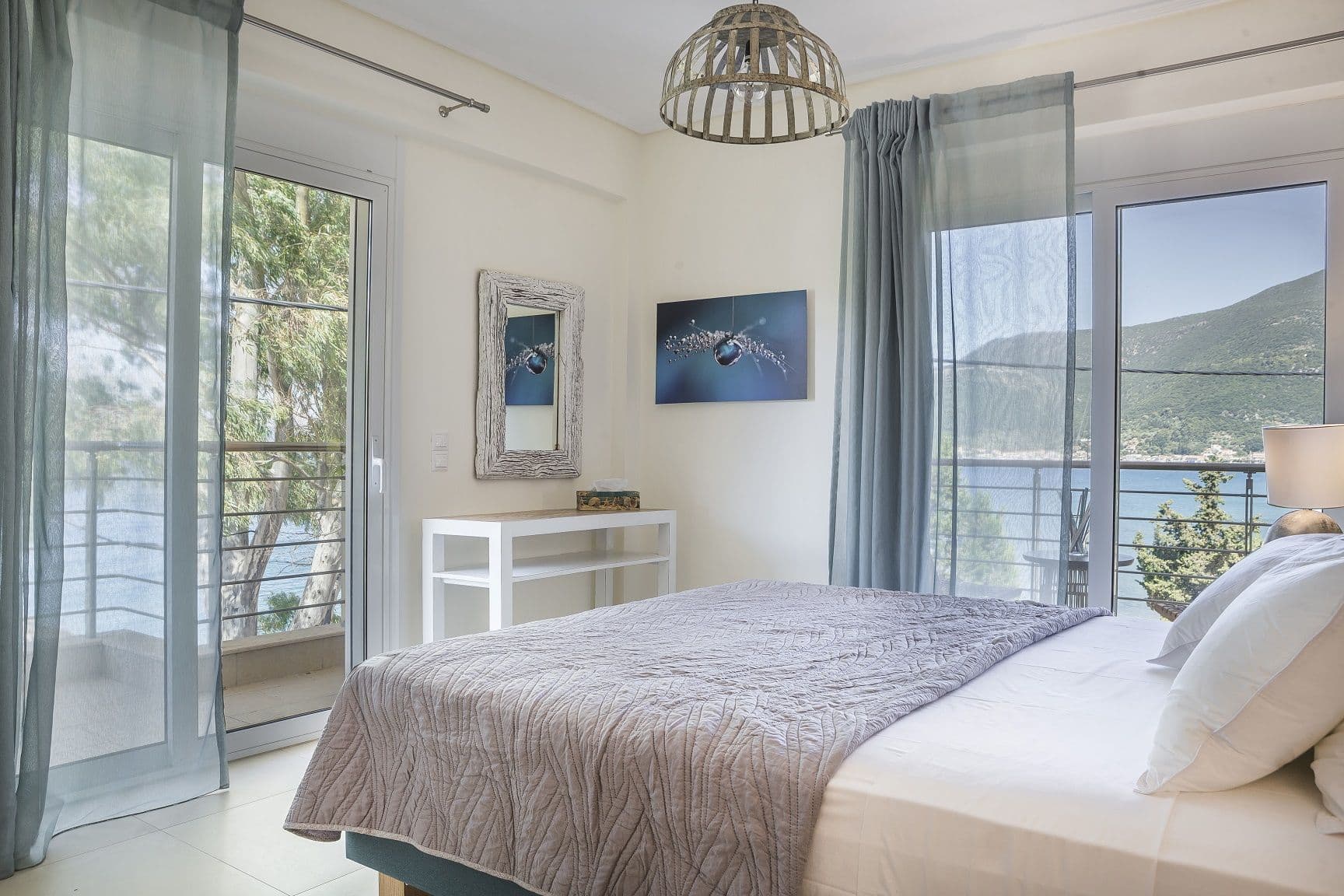 Sea views pouring into the interior of one of Ammos Suite’s corner bedrooms, one of the most ideal family apartments in Kefalonia.